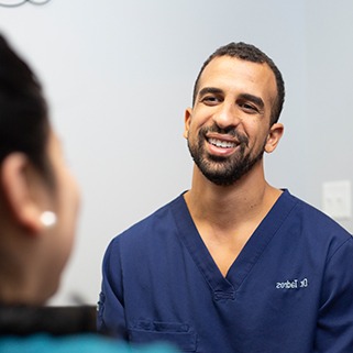 Dallas dentist Doctor Tadros smiling at dental patient