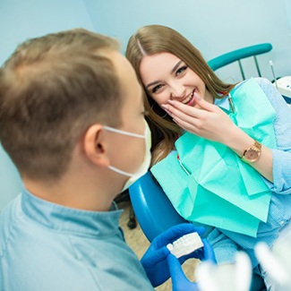 Young woman smiling at sedation dentist in Dallas