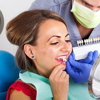 A woman reviewing veneers with a cosmetic dentist