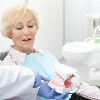 Dentures patient in Dallas talking to dentist