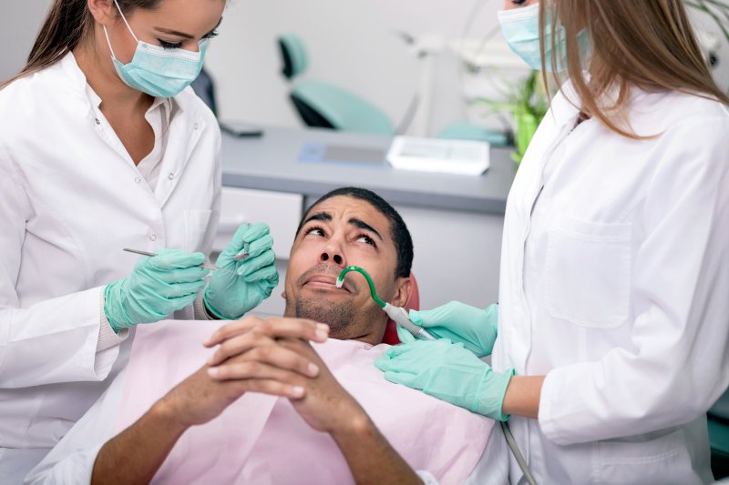 A nervous man getting a cosmetic dental treatment